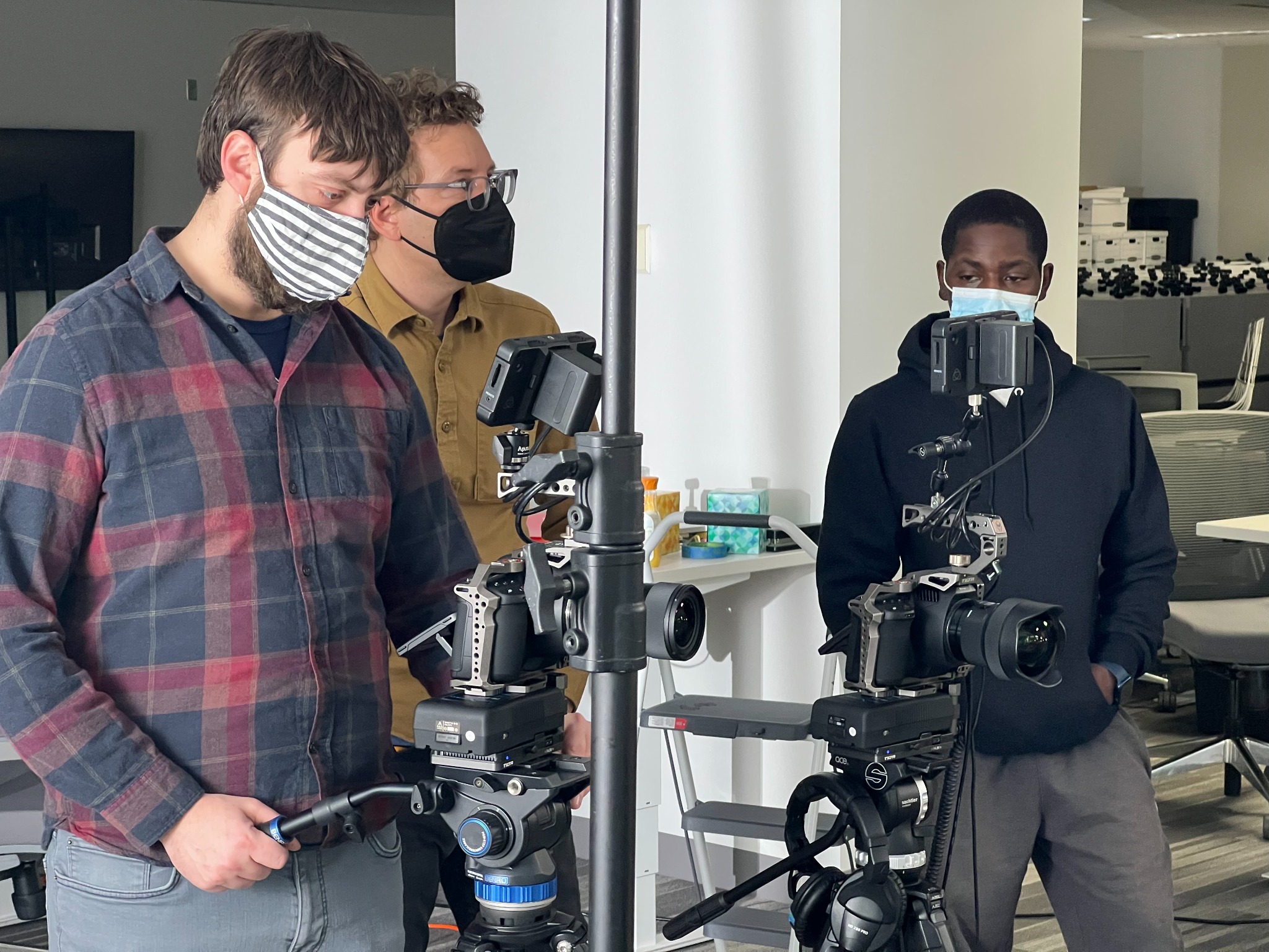 Drift camera team reviewing two production cameras before filming
