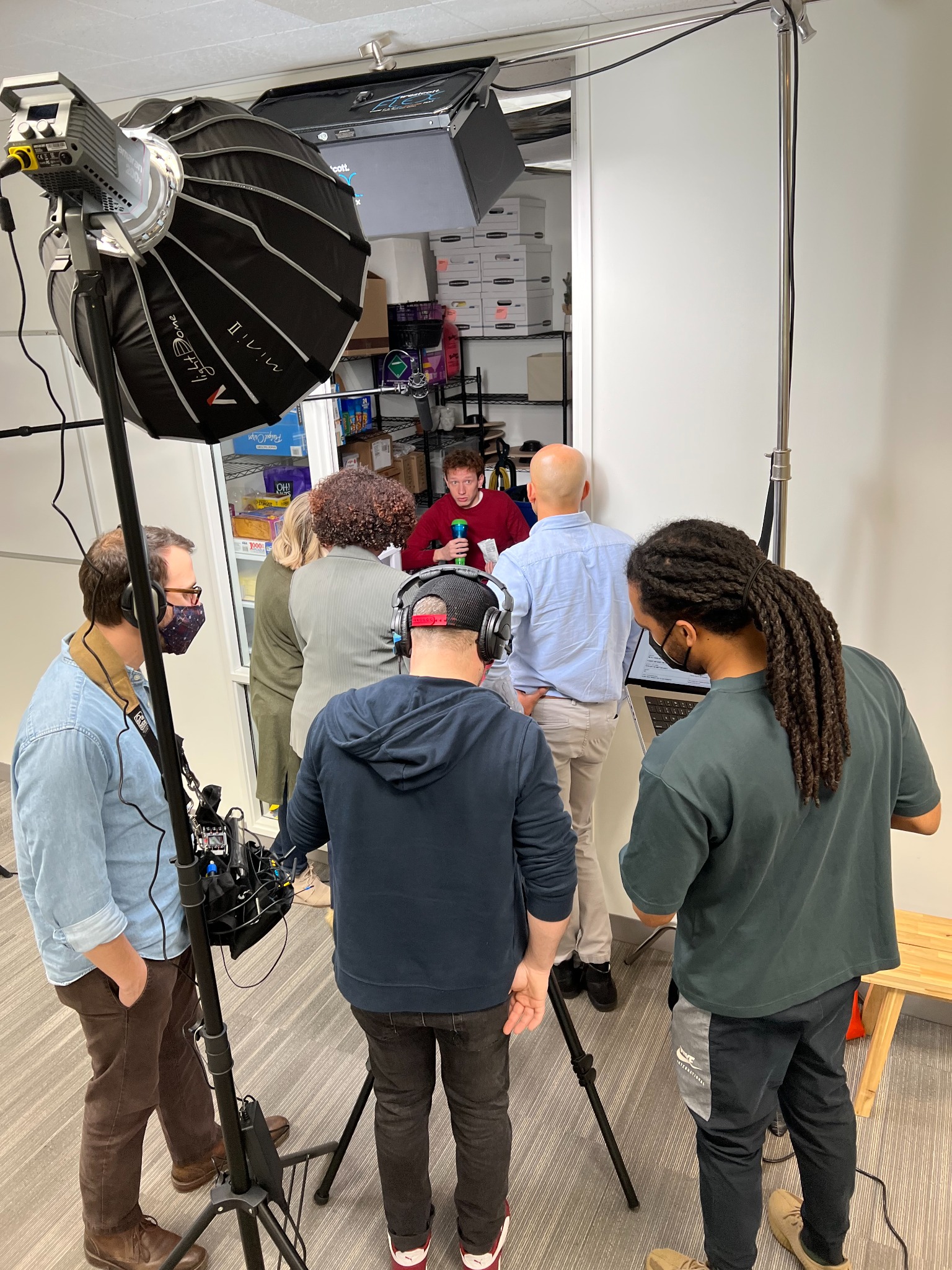 Cabrell Cooper and production team reviewing the scene with a laptop on set