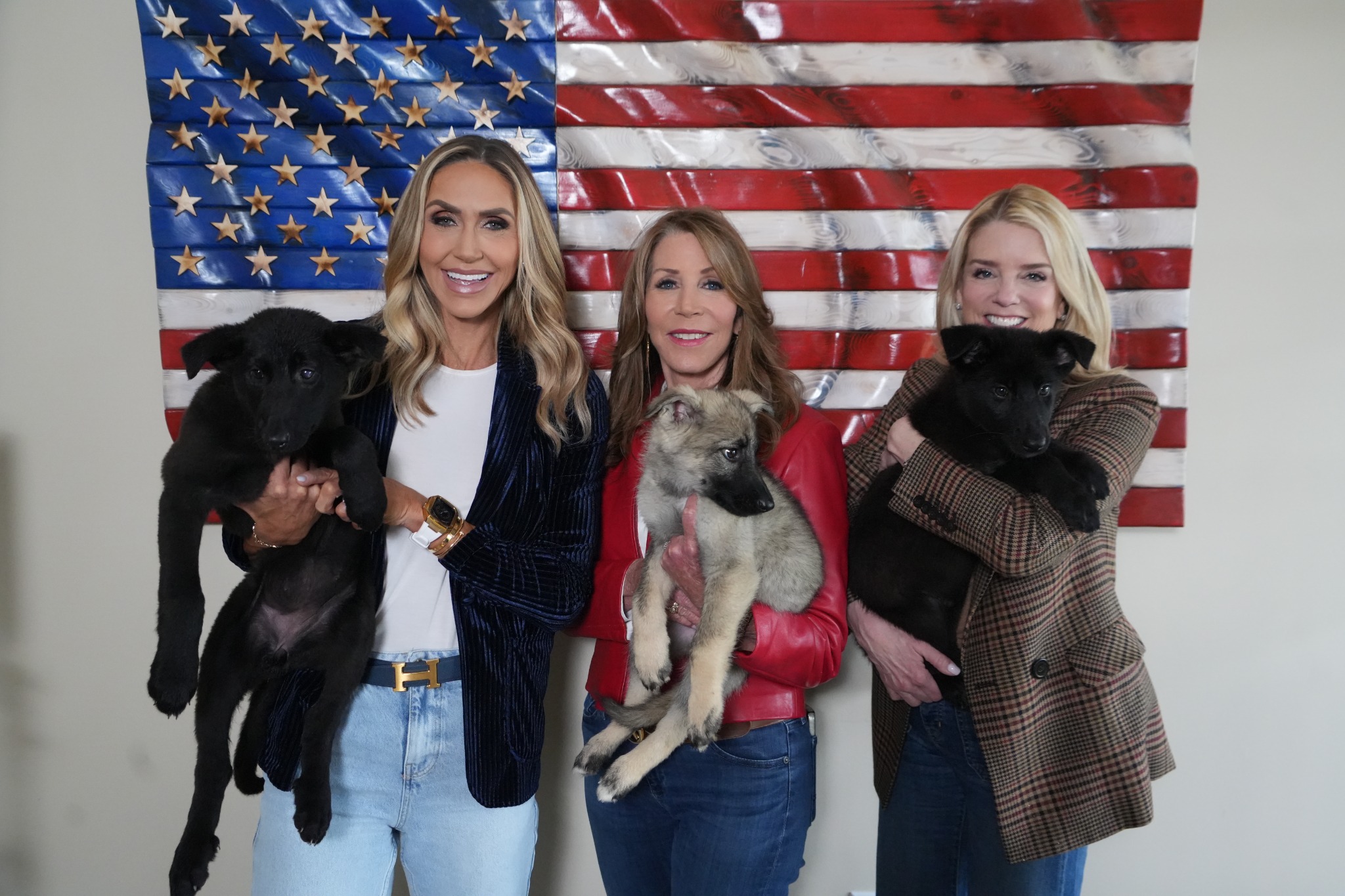 Community event portrait with puppies and American flag artwork